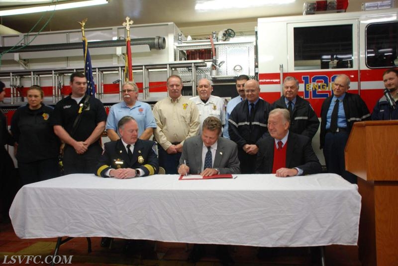 A.A.County Executive Steve Schuh signs the new Volunteer LOSAP bill at the Earleigh Heights VFC